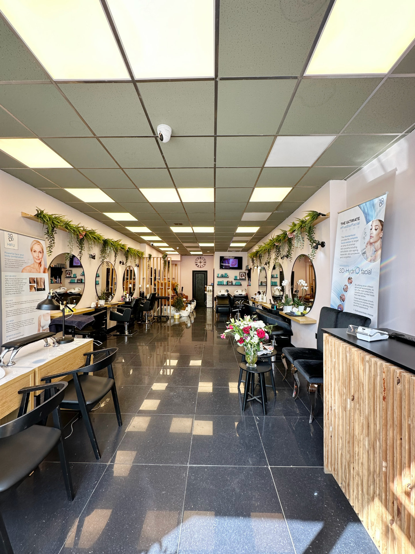The main salon floor at Chic Salon & Clinic with mirrored styling stations and trailing greenery.